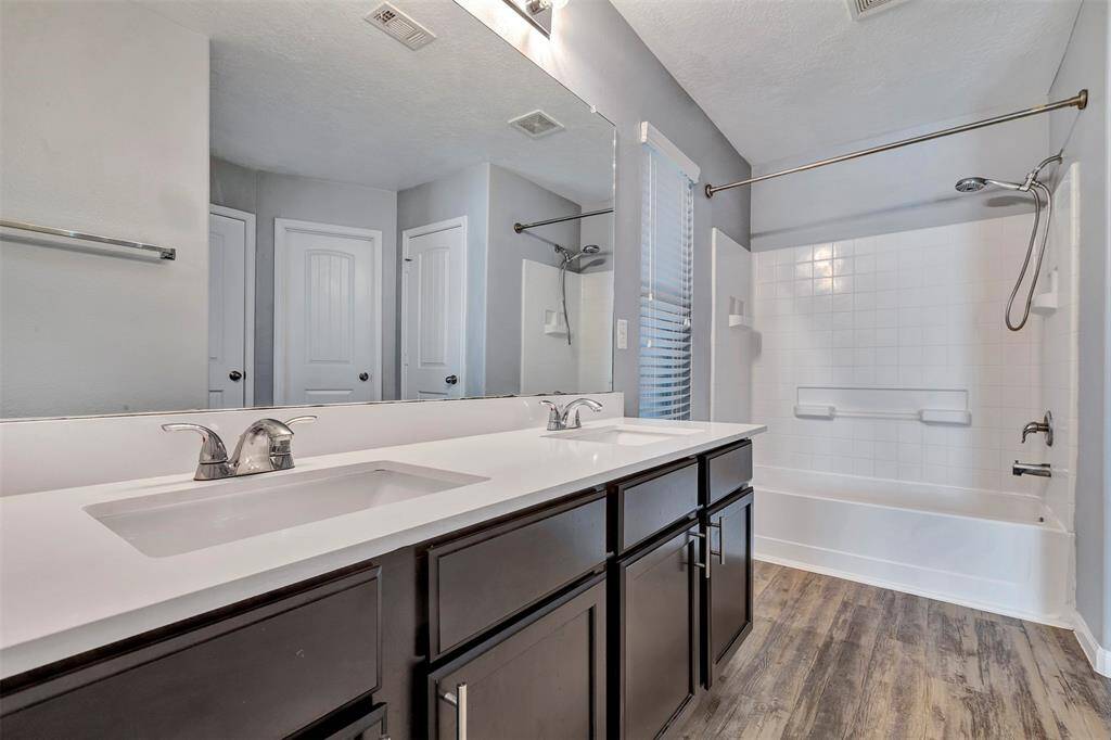 Updated primary bath with double sinks and tub/shower combo