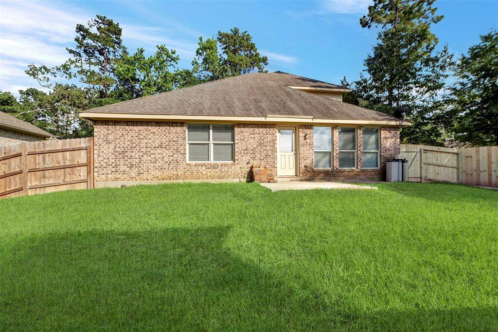 Spacious backyard with new fence next to green space