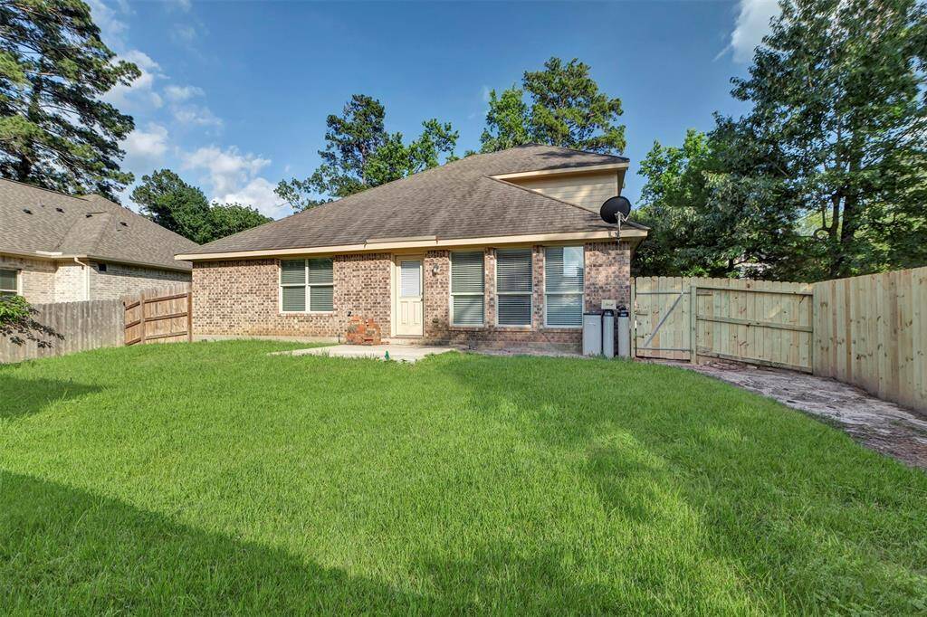 Spacious backyard with new fence next to green space