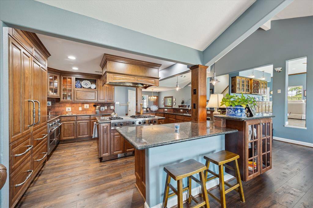 A breakfast bar that serves into the den is at the end of the wrap around outer side of the kitchen. This view into the kitchen is from within the den.
