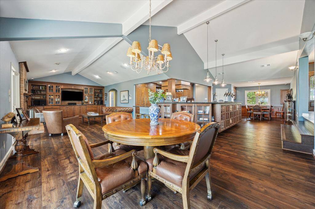 This view across the breakfast area provides a look into the den, kitchen and formal dining room.