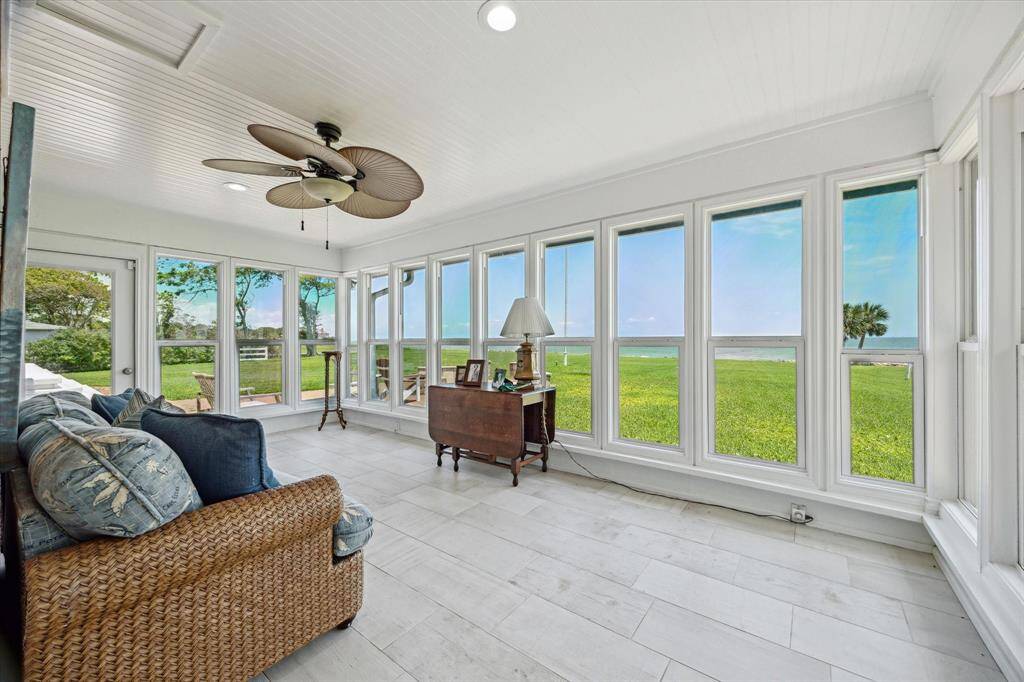 The sunroom is surrounded by a wall of windows that provide incredible sunrise and sunset views over Galveston Bay.