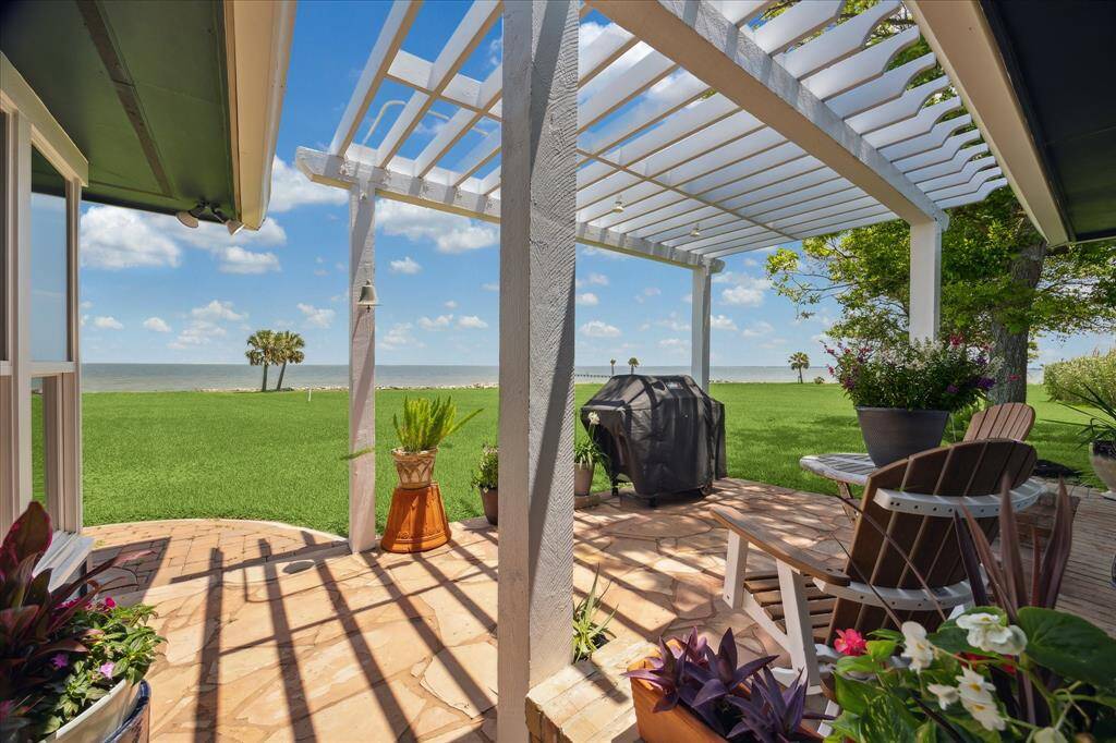 A flagstone surfaced patio at one side of the sunroom serves as a great place for the gas grill and has a fantastic bay view.