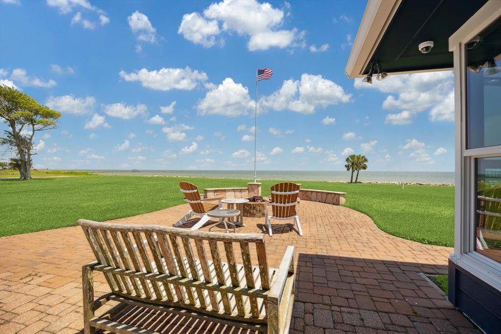 The other side of the sunroom leads to an additional portion of the patio that includes a built-in firepit.