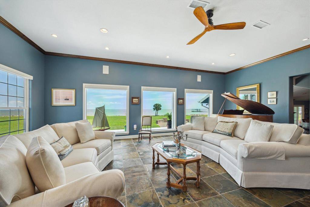 The rear wall of the family room has three 58"x70'" windows that over look the bay. The views through the windows in this photograph are not enhanced. This is the actual view toward the bay.