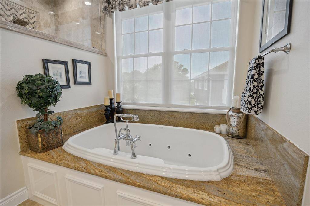 The primary bath has a separate jetted tub.