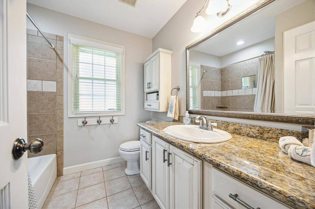 Full bath 3 has a tub/shower combo with tile surround, a granite topped vanity and is located convenient to bedrooms 2 & 3.