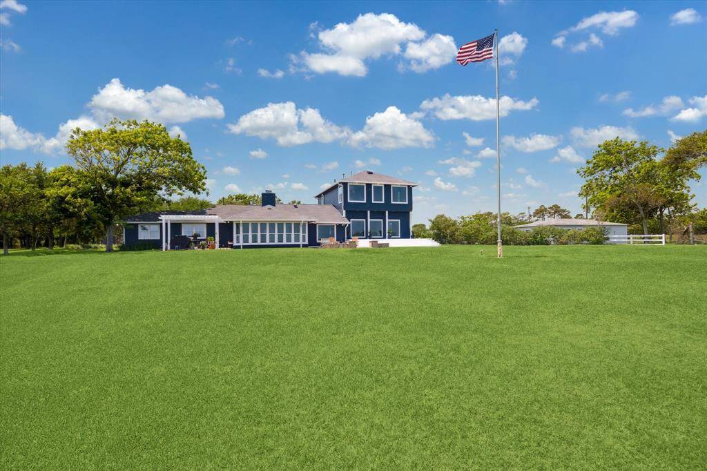 This property has an expansive lawn area between the house and the bayfront.