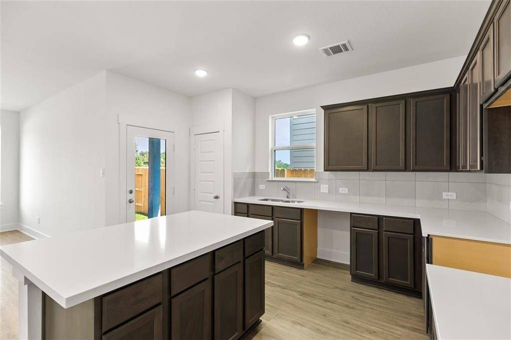 This kitchen isn’t just a place to cook; it’s a space where memories are made, where family traditions thrive, and where you can feel truly at home. Microwave, Dishwasher, Stovetop range are included, just not pictured.