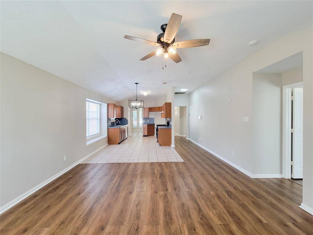 Enjoy seamless views of the open den, breakfast nook, and kitchen from the back door.