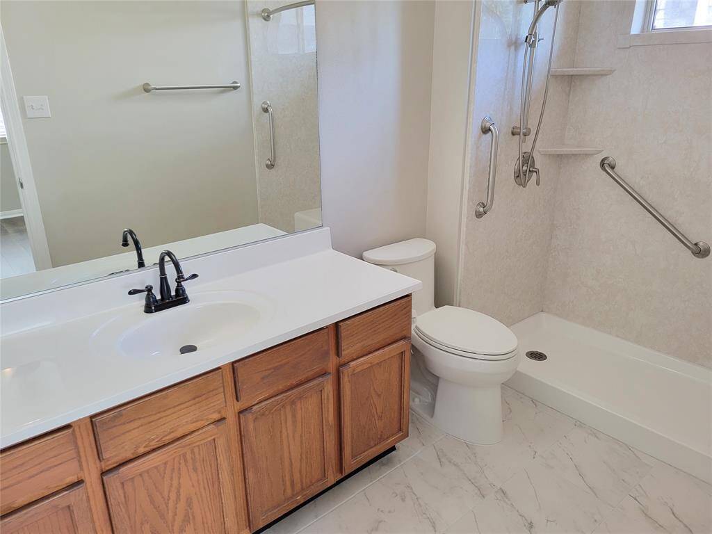Inviting primary bath with fresh, elegant tile flooring.