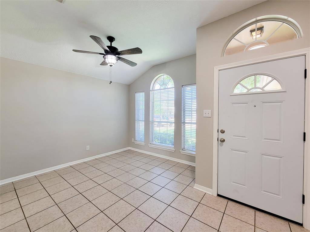 Welcome to a versatile foyer that flows into a spacious area, perfect for dining or a home office.