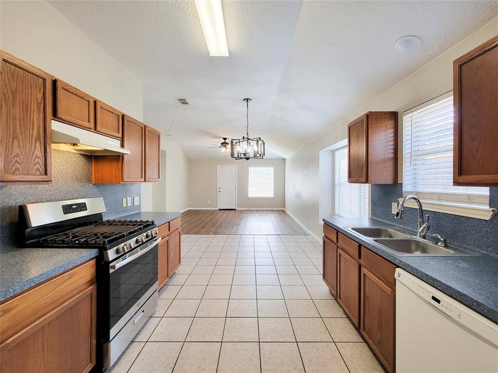 Spacious kitchen seamlessly connects to a cozy breakfast area and inviting den.