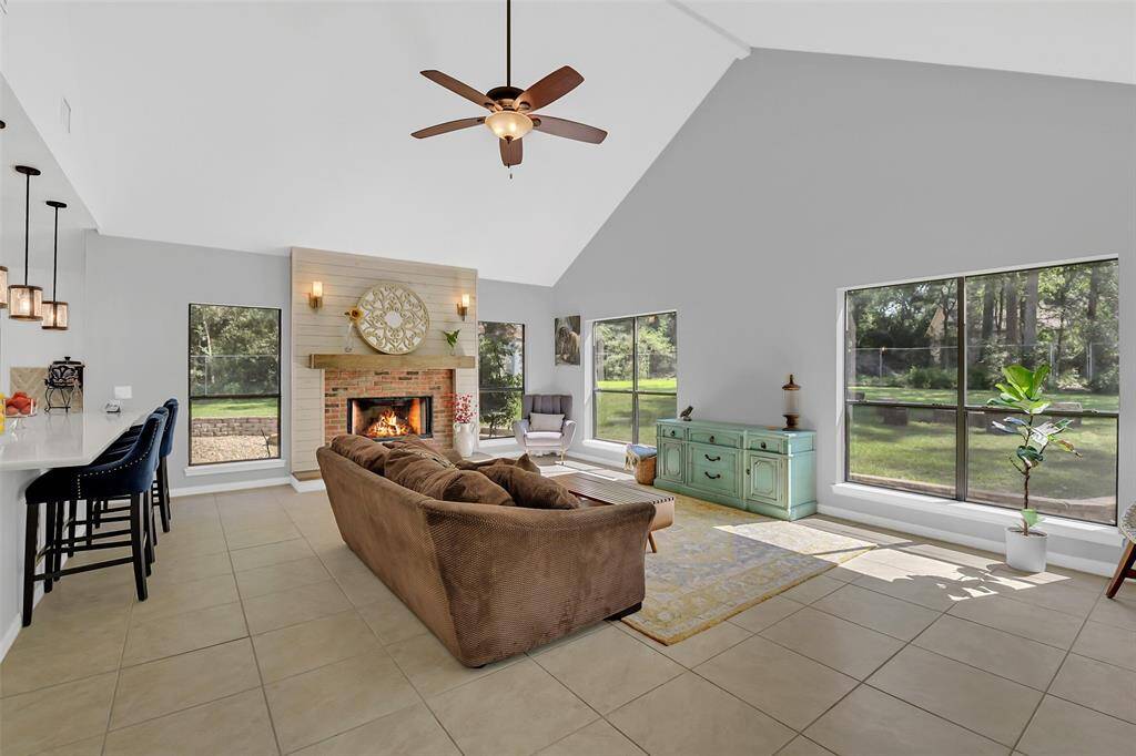 View of the living room with walls for light and a stunning fireplace.