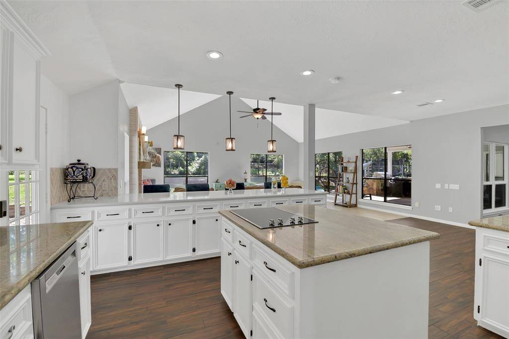 Spacious kitchen with island and cooktop.