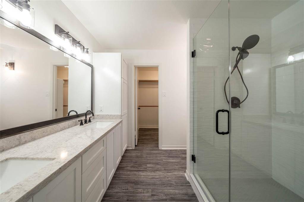 Updated primary bath with dual sinks and shower bench