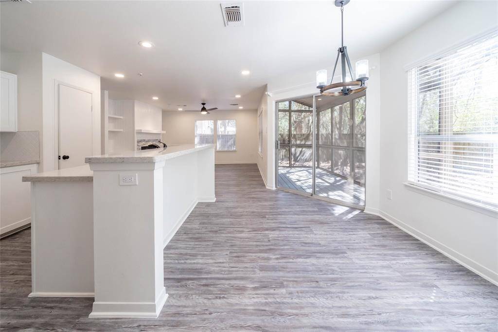 Kitchen features granite countertops with a bar and stainless steel appliances