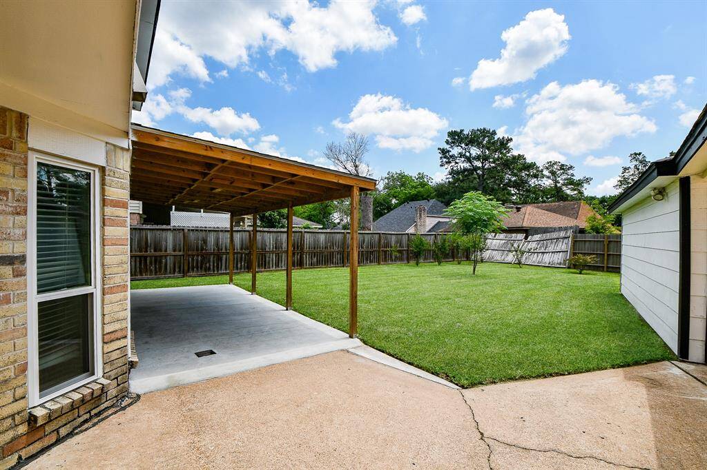 This inviting backyard features a covered patio area