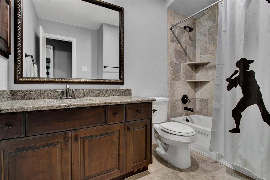 Secondary bath that is shared by the game room and 2 bedrooms.