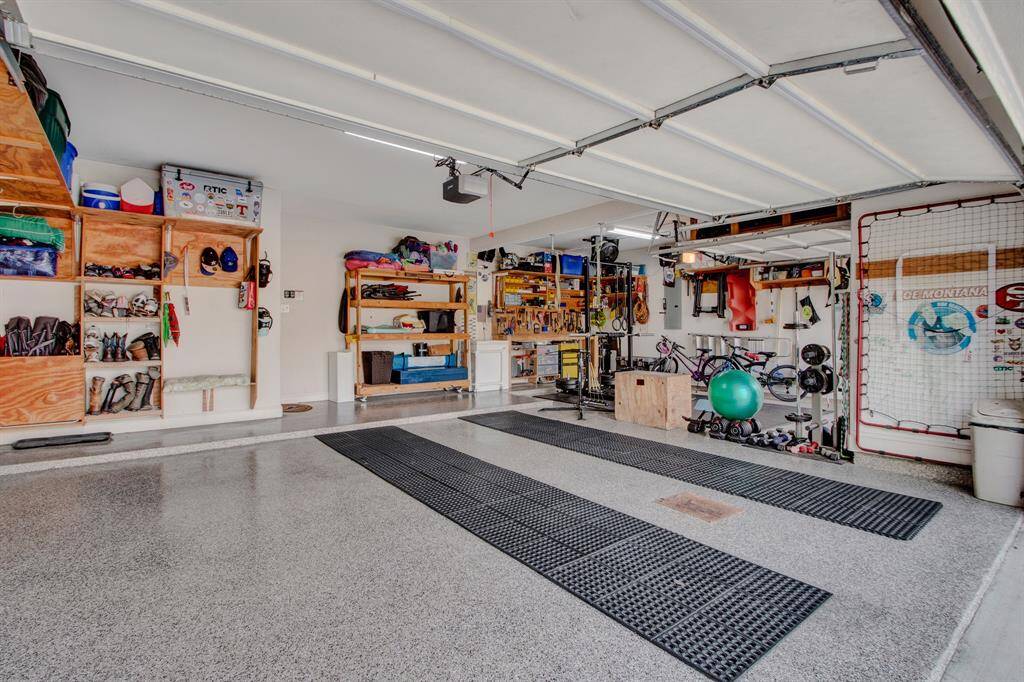 A garage for the neighbors to envy! A true 3-car with epoxy flooring and lots of built-in shelves for extra storage