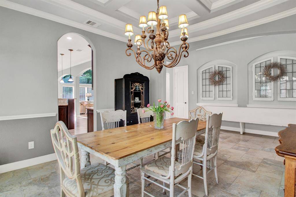 Formal dining room is the perfect place for a special meal, or to entertain a crowd!  Sophisticated yet warm and inviting.  Chair rail detail and another spectacular ceiling!