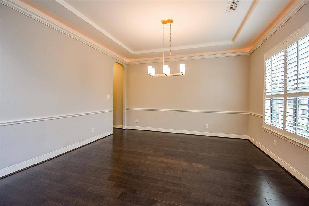 Two-Story Highceiling Open Living Room or Home Office (Virtually Staged) with Plantation Wood Shutters.