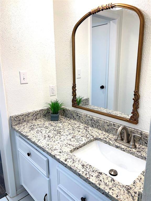 Secondary bathroom sink independent of shower area.