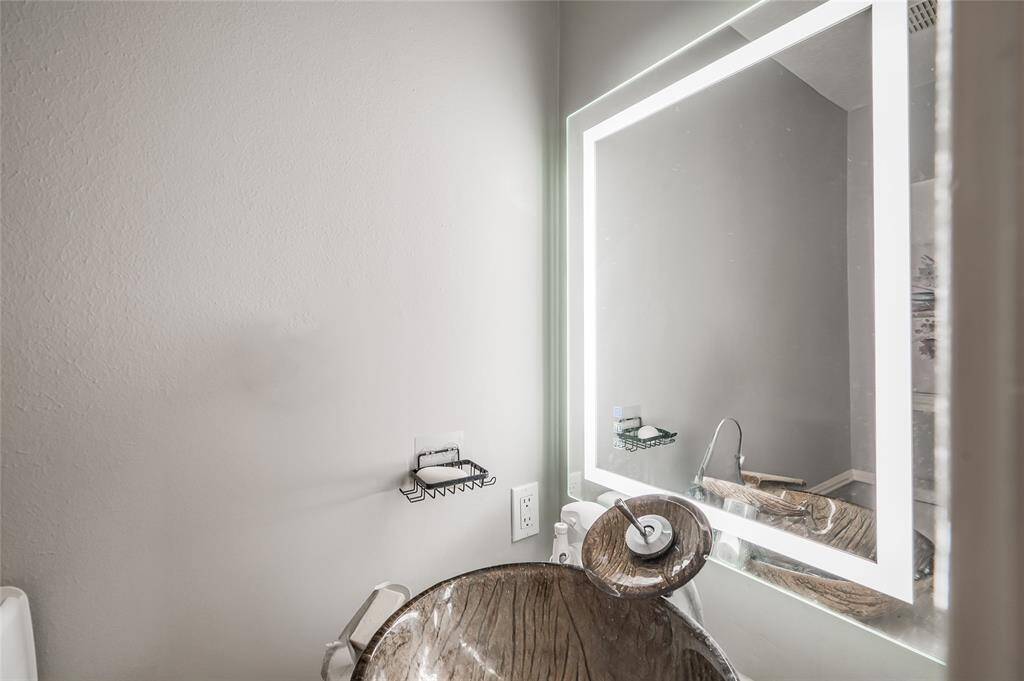 The half bath, ideal for guests and everyday use, this well-designed space features modern fixtures and elegant finishes, offering both practicality and a touch of sophistication. The half bath ensures that your full bathrooms remain private, making it a valuable addition for entertaining and busy households alike.