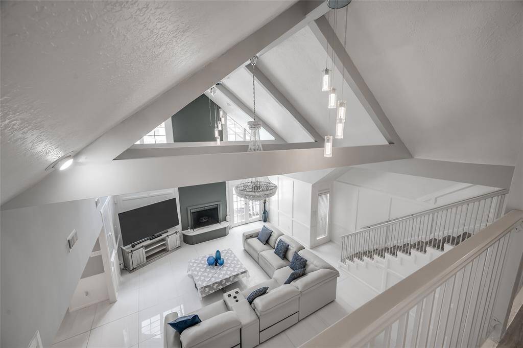 Enjoy a stunning vantage point with a beautiful view of the living room from the second floor. The elevated perspective provides a striking architectural element, making the living area feel even more grand and inviting.