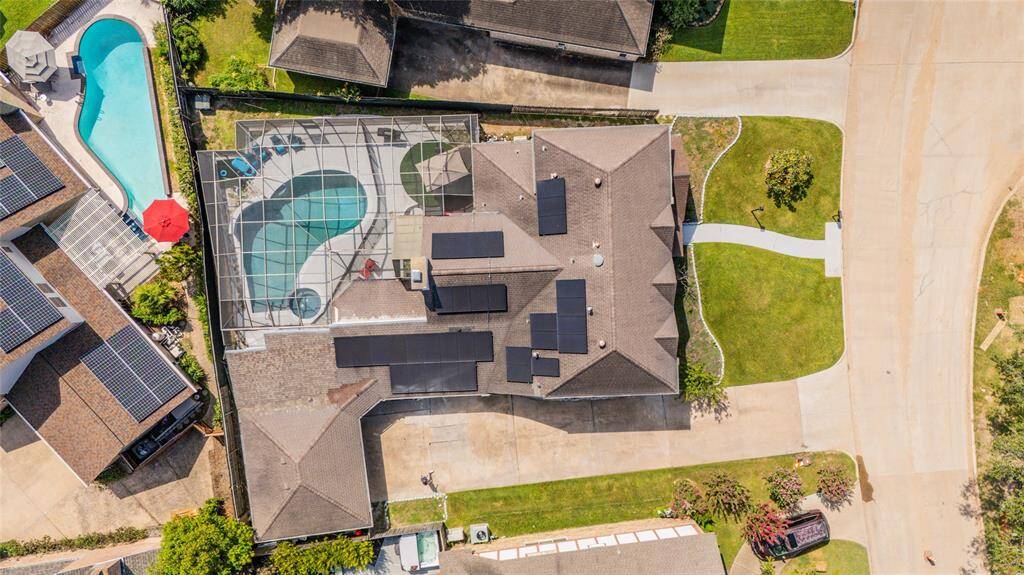 Here’s a bird's-eye view of the home, showcasing its layout and architectural design from above. This perspective highlights the thoughtful arrangement of living spaces, outdoor areas, and overall flow of the property, offering a comprehensive look at the home’s layout and surroundings.