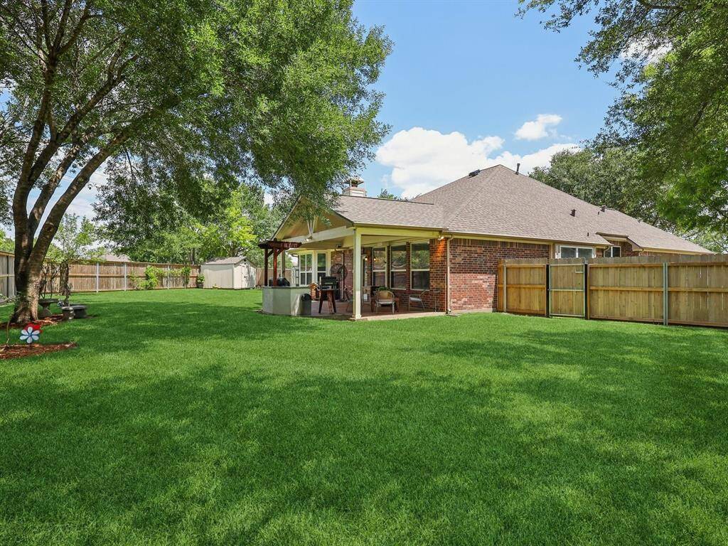 Gorgeous trees adorn the backyard, providing shade and a park-like feel!