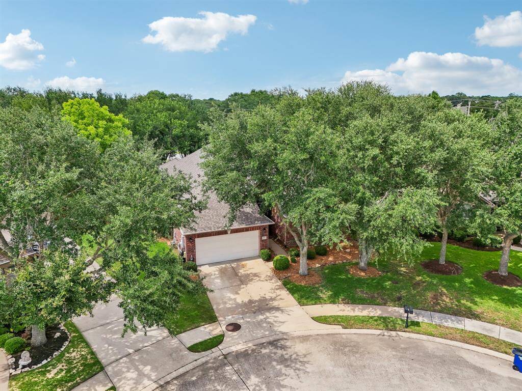 This aerial says it all! The mature trees give this home a park-like feel.