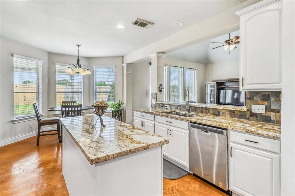 Just off the kitchen, the bright and airy breakfast area is surrounded by windows, offering a scenic spot to enjoy your meals and soak in natural light.