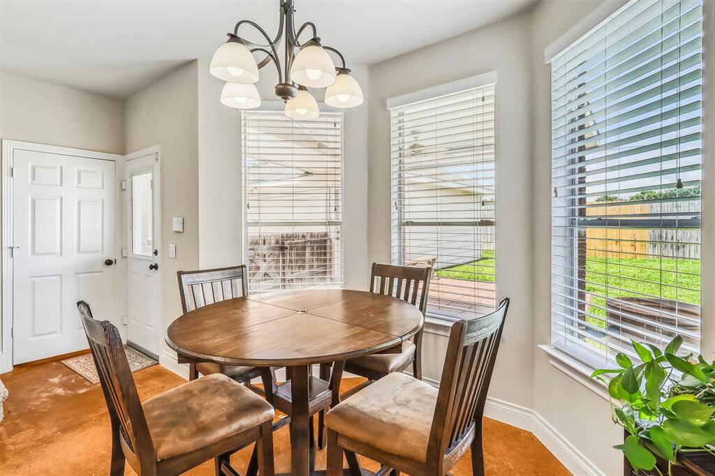 The breakfast bar is an ideal spot for a round table and chairs, with a charming chandelier hanging overhead. Enjoy views of your expansive backyard, and take advantage of the easy access to outdoor living.