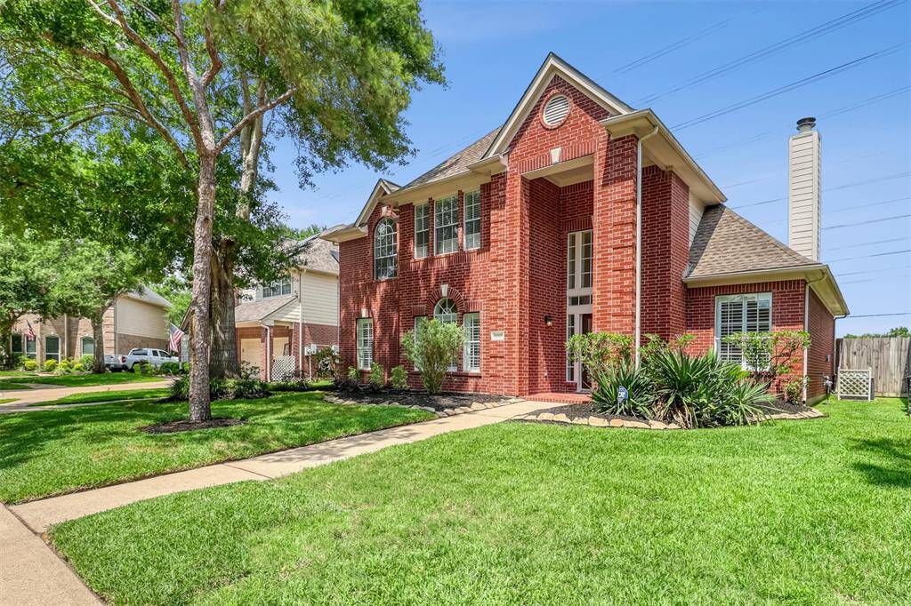 Enjoy a spacious front yard with mature landscaping framed by elegant stone borders. This 4-bedroom, 2.5-bath home combines charm with practicality, featuring full gutters for added durability and low-maintenance living.