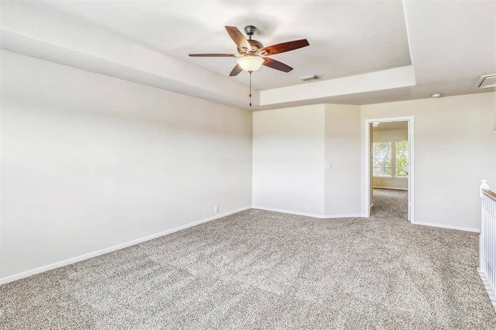 This spacious game room offers plenty of room for a large sectional and media equipment, or even a billiards table and gaming setup—perfect for entertainment and relaxation.