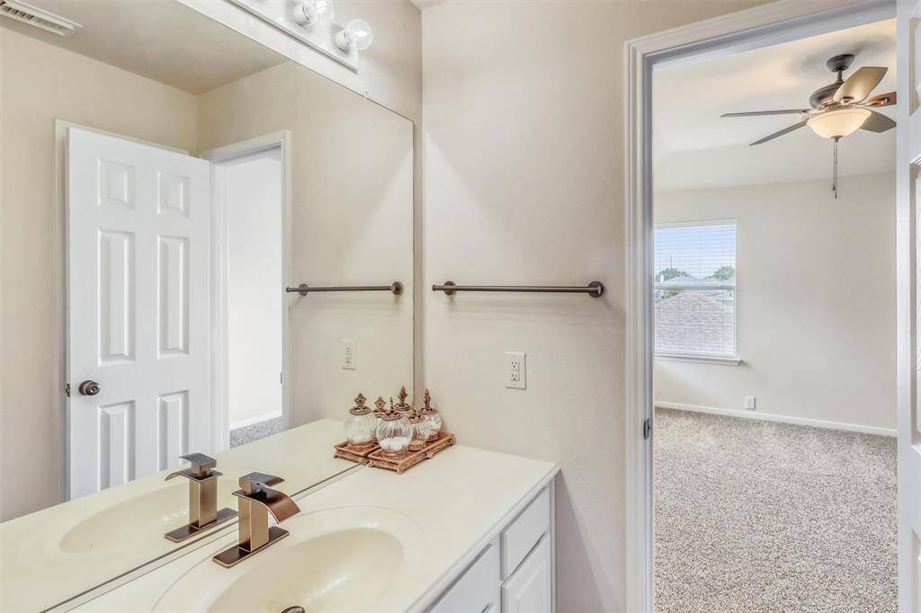 The second vanity mirrors the first, with matching white cabinetry, countertops, and an updated faucet—creating a cohesive and functional shared space.