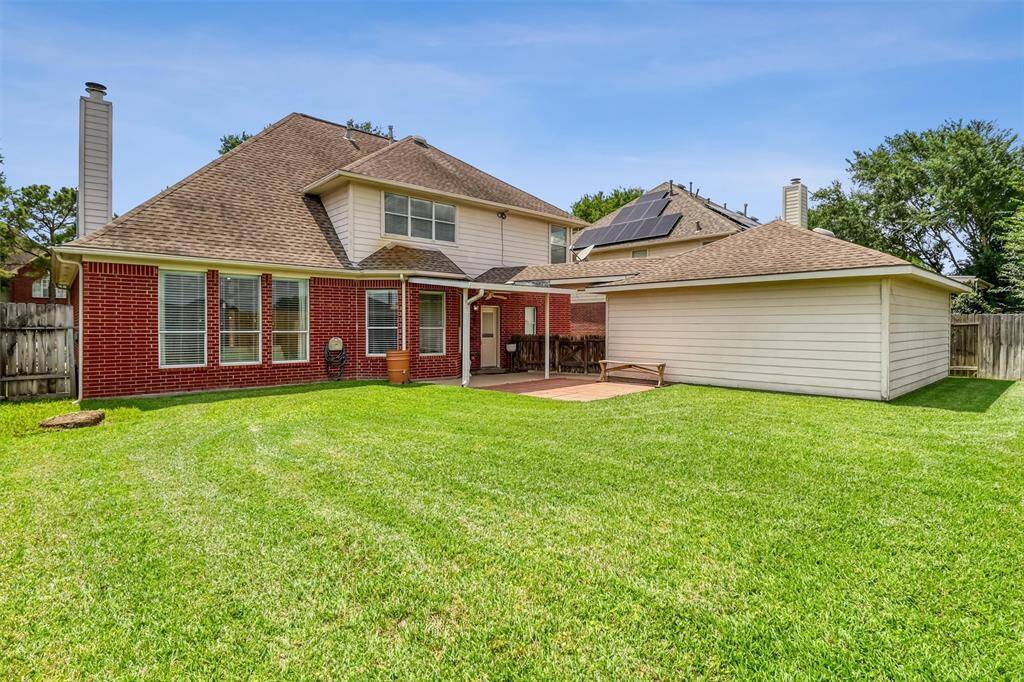 The lush green space andfully fenced backyard offer both privacyand plenty of room for outdoor activities.