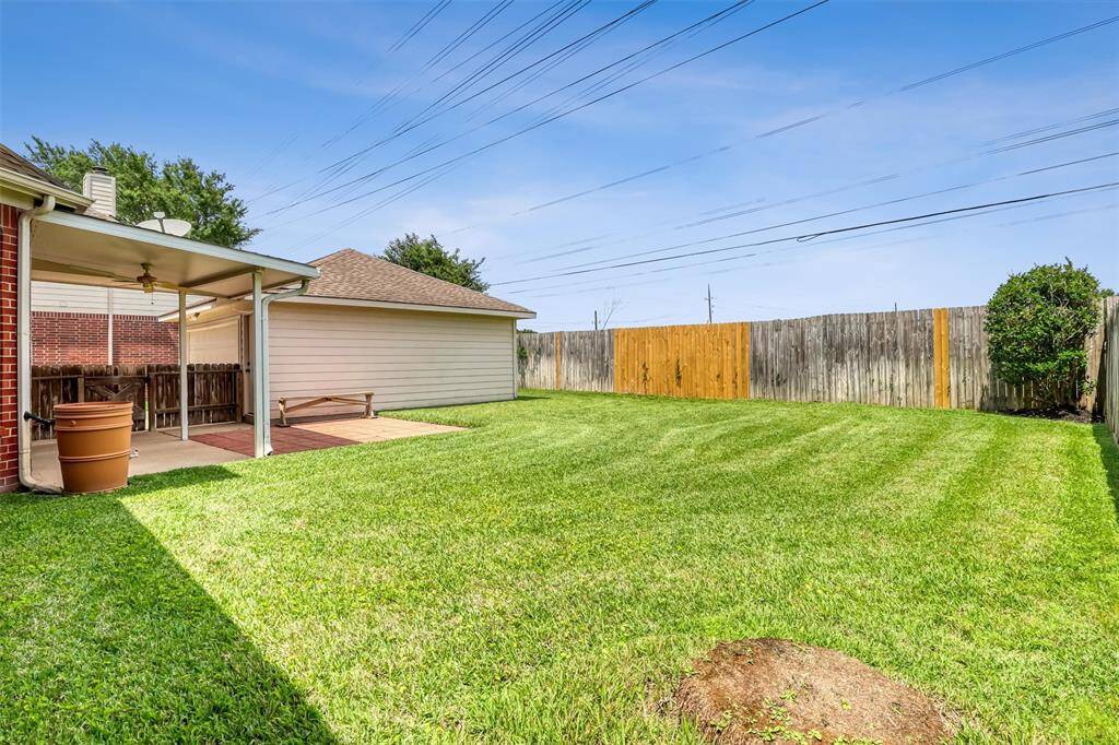 Relax on the covered patio with paver extension and enjoy the privacy of no back neighbors and a peaceful greenspace behind the property.