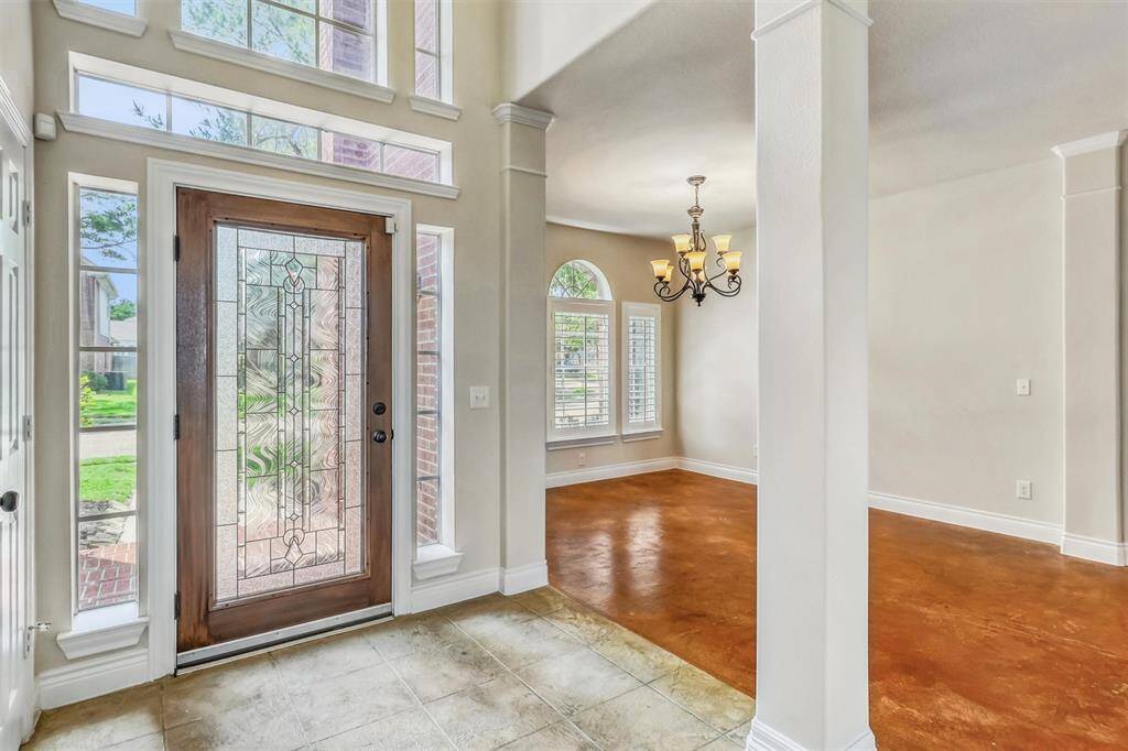 Step inside to an elegant entryway that sets the tone with soaring ceilings, abundant natural light, and fresh, neutral paint throughout—creating a bright and inviting first impression.