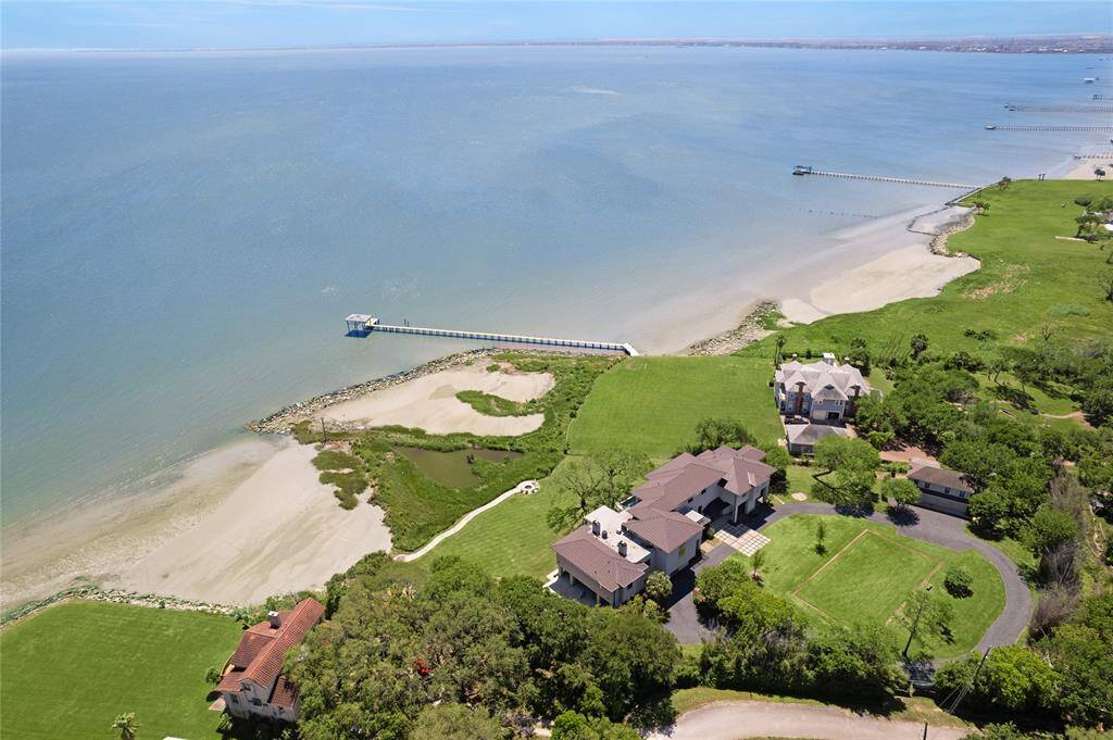 Take a dip in your secluded pool overlooking the bay. A few steps away is a grand covered patio with a summer kitchen and surround sound!
