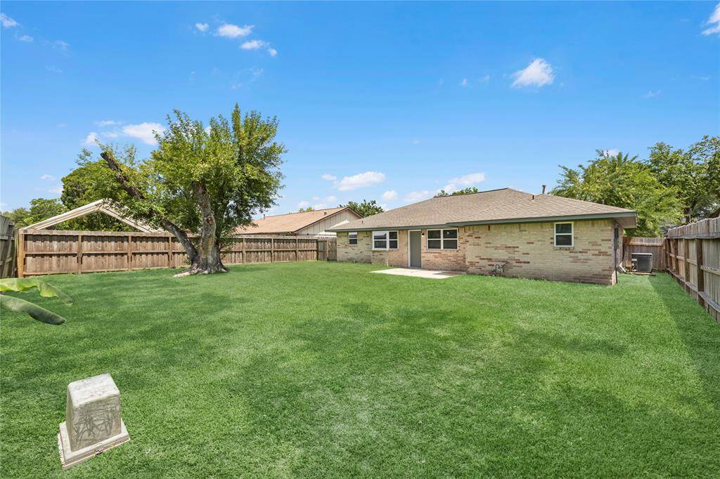 Well-maintained lawn and patio area, perfect for outdoor living.