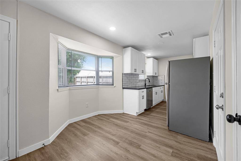Sleek appliances and a modern backsplash complete this updated kitchen.