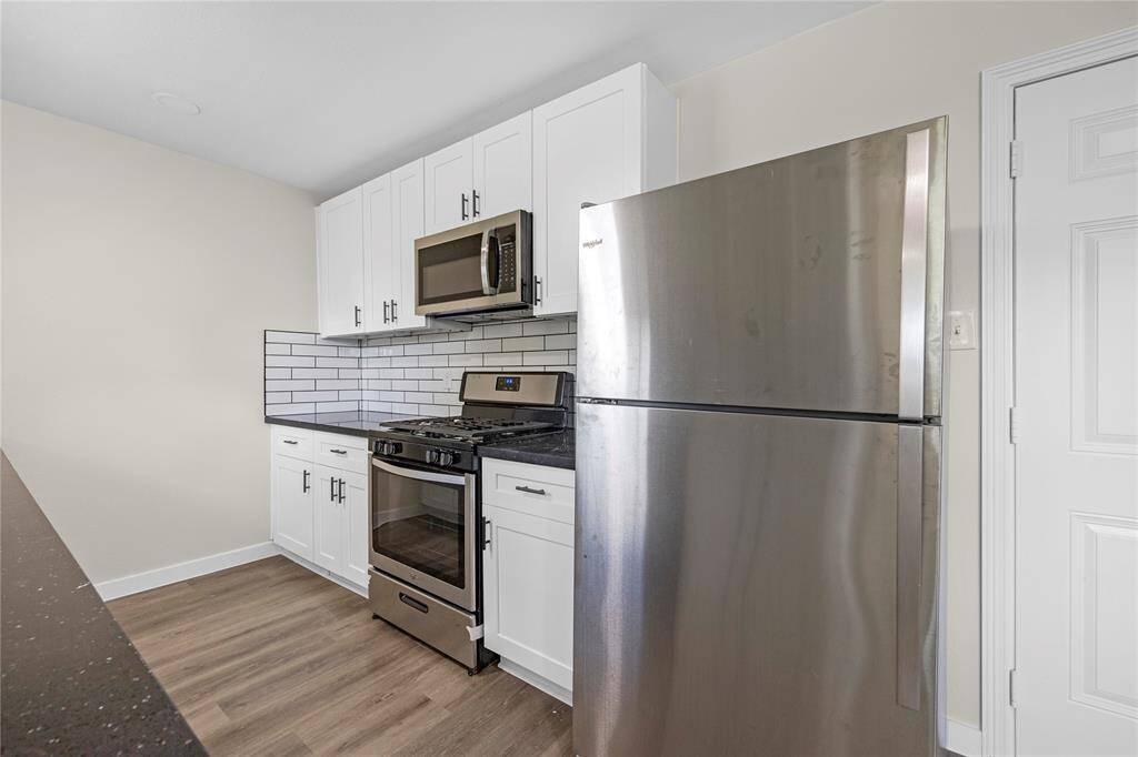 Sleek appliances and a modern backsplash complete this updated kitchen.