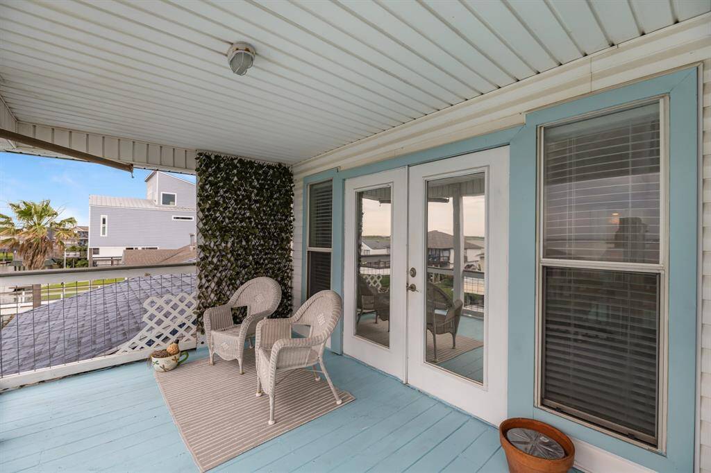 Private balcony off the primary bedroom offers a serene retreat with charming views.