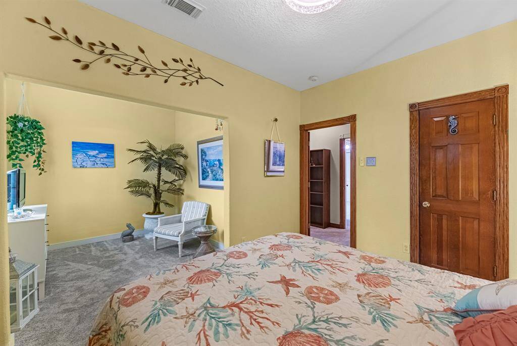 Charming secondary bedroom featuring a cozy sitting area, perfect for relaxation or reading.