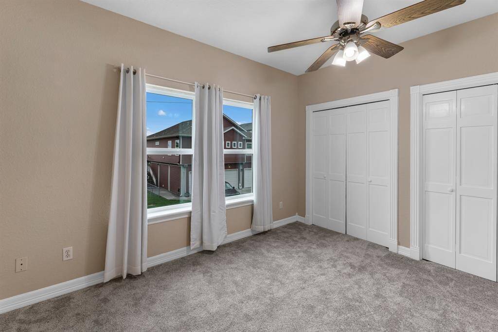 Cozy third bedroom with ample natural light and spacious closet.