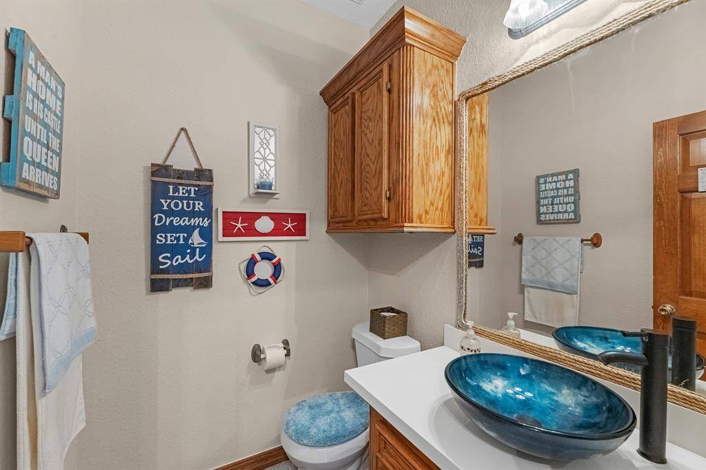 Charming half bath with elegant vessel glass sink.
