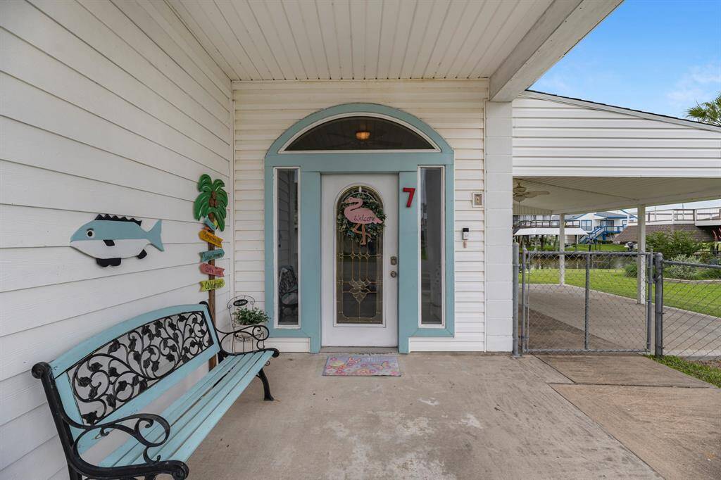 Charming front entrance with a covered porch. .