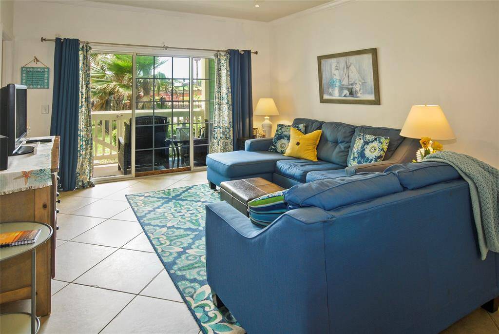 Living room looks out to patio and front green space.